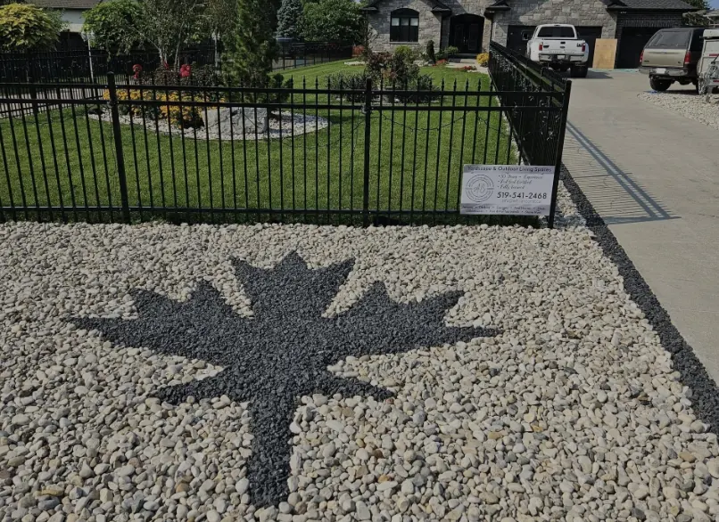 Maple-leaf gravel inlay and wrought iron fence