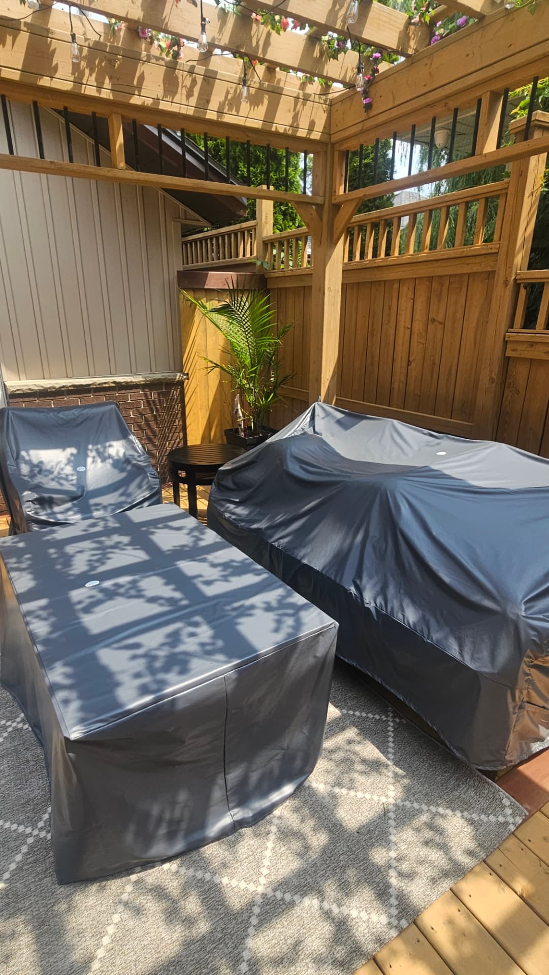 Covered lounge furniture under a cedar pergola on a private cedar deck