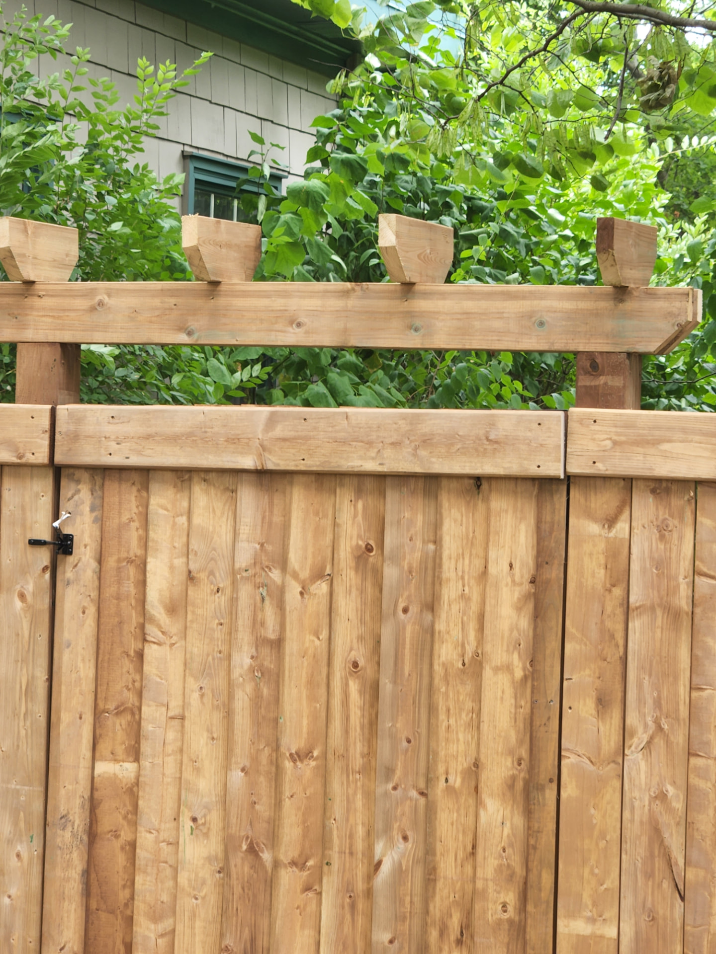 Cedar privacy fence with a custom decorative post-top detail