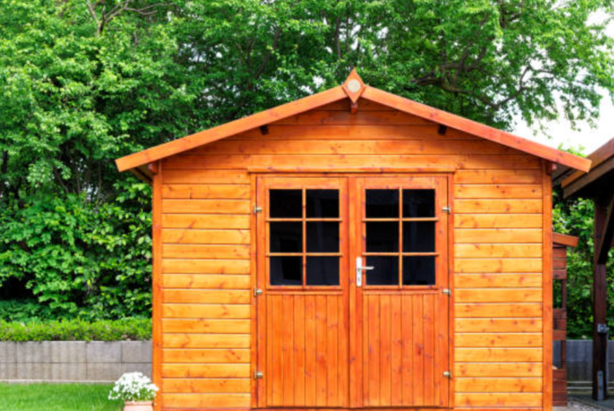 Custom cedar garden shed with double doors and a shingled roof built on a Sarnia property