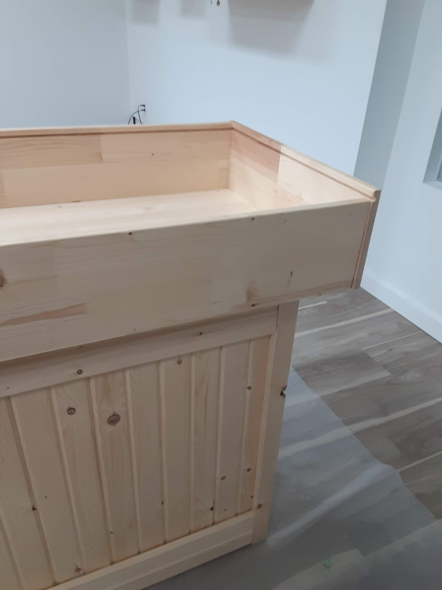 Custom unfinished wood counter and cabinetry during an interior renovation
